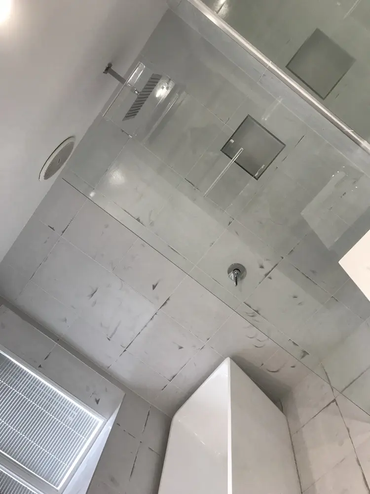 Bathroom before epoxy coating, showing existing tiled walls