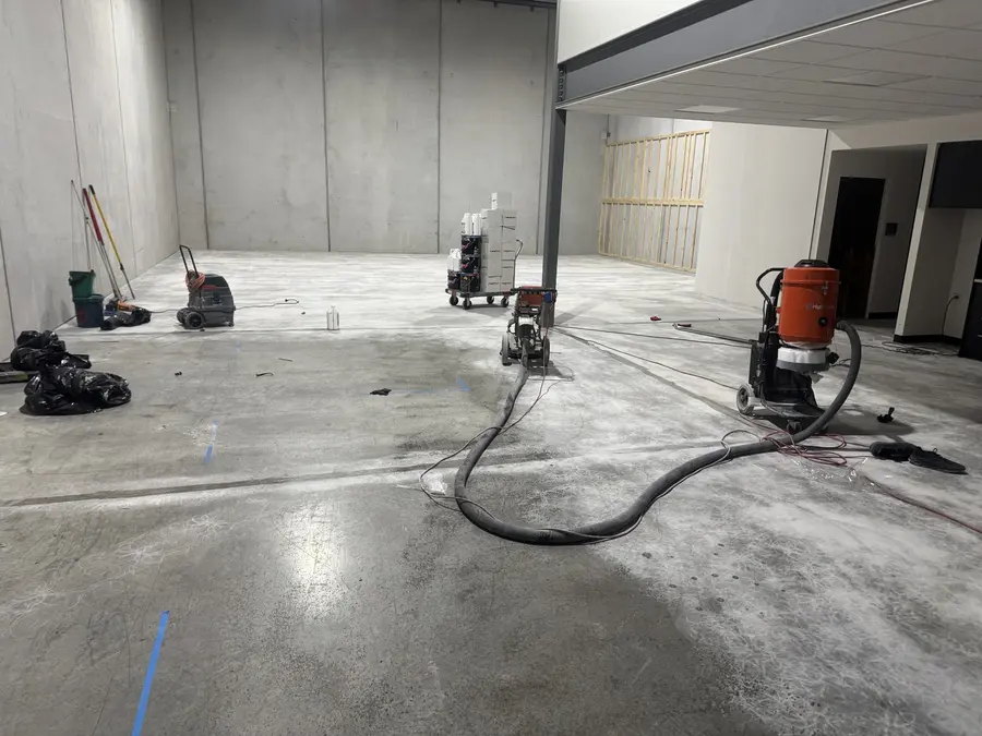 Concrete grinding equipment during floor preparation