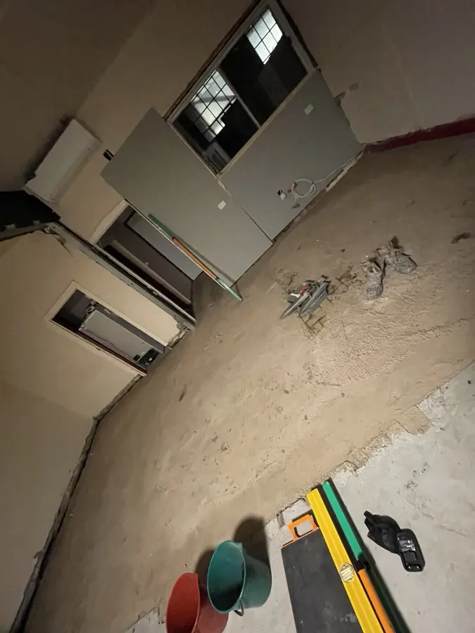Mortar screeding and levelling work with tools on the surface